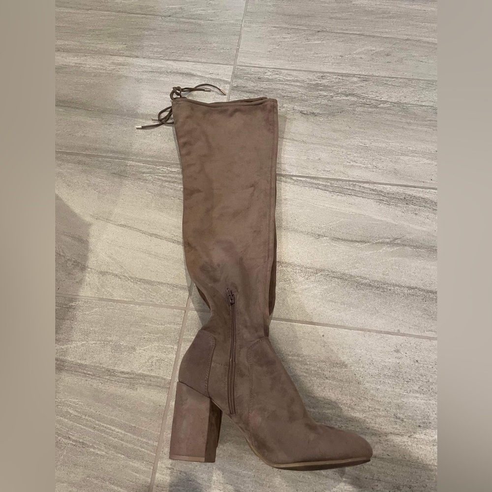 Tan thigh high suede boots.